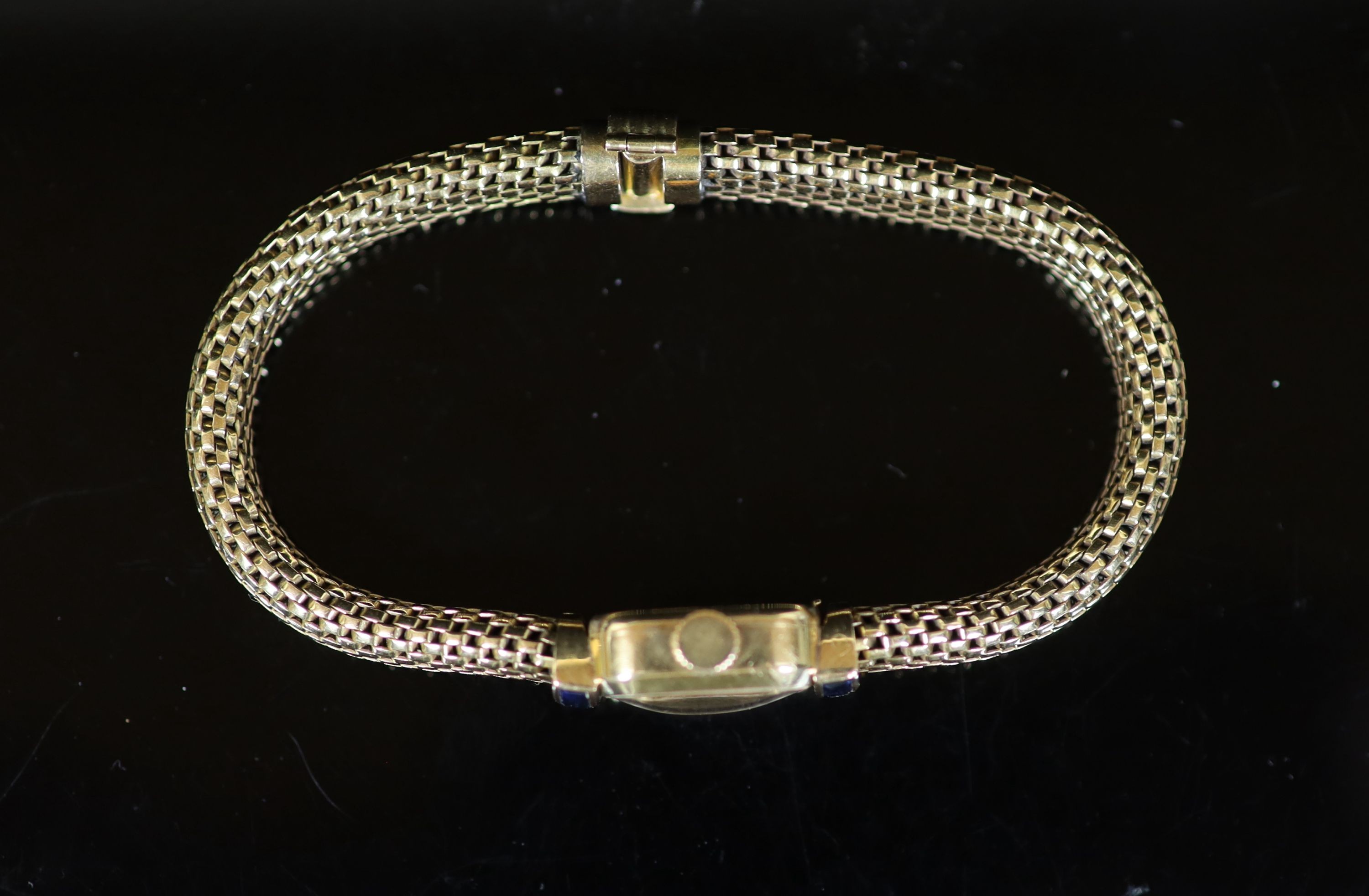 A lady's mid 20th century French Boucheron 18ct gold and six stone sapphire set manual wind cocktail watch, on an integral 18ct gold 'cage link' bracelet